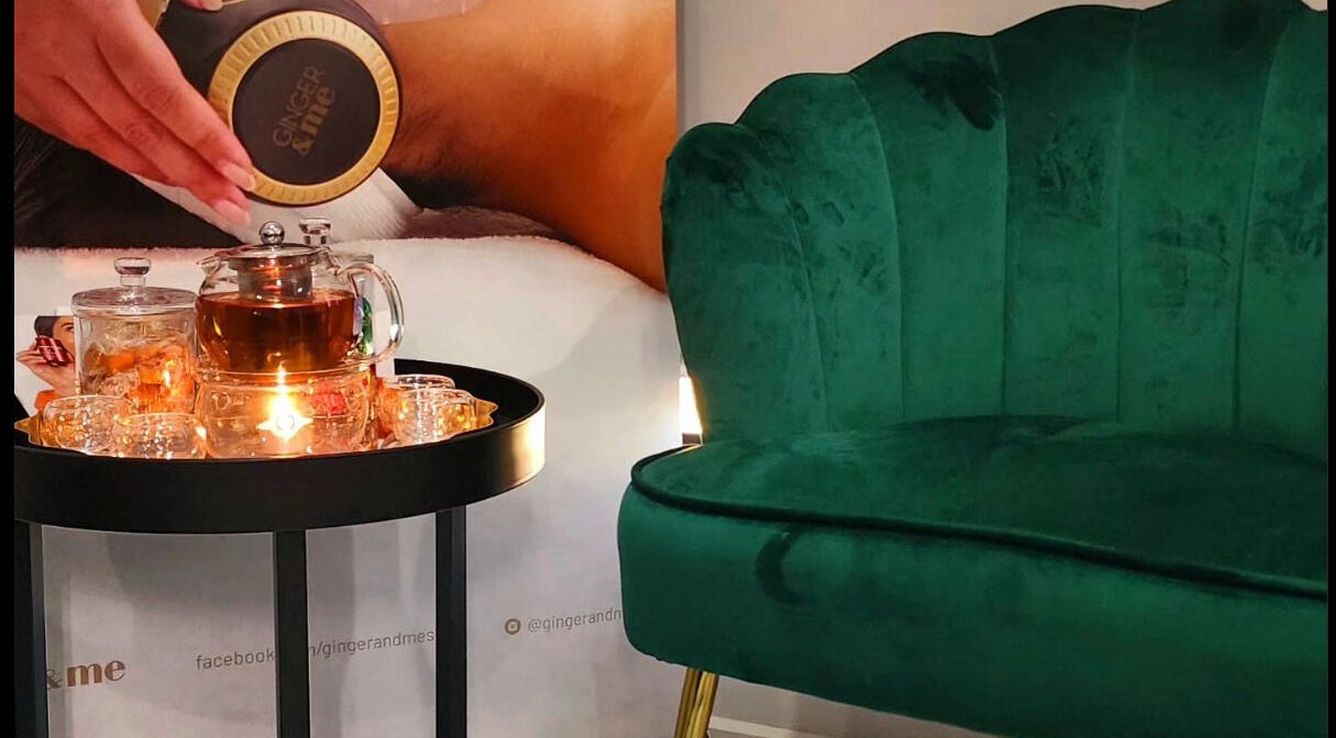 Cozy lounge at Beauty by Manola, Bayview, Northern Territory, AU with a green chair and tea set.