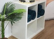 Elegant spa corner at Beauty by Manola, Bayview, Northern Territory, AU, featuring green plants and rolled towels.