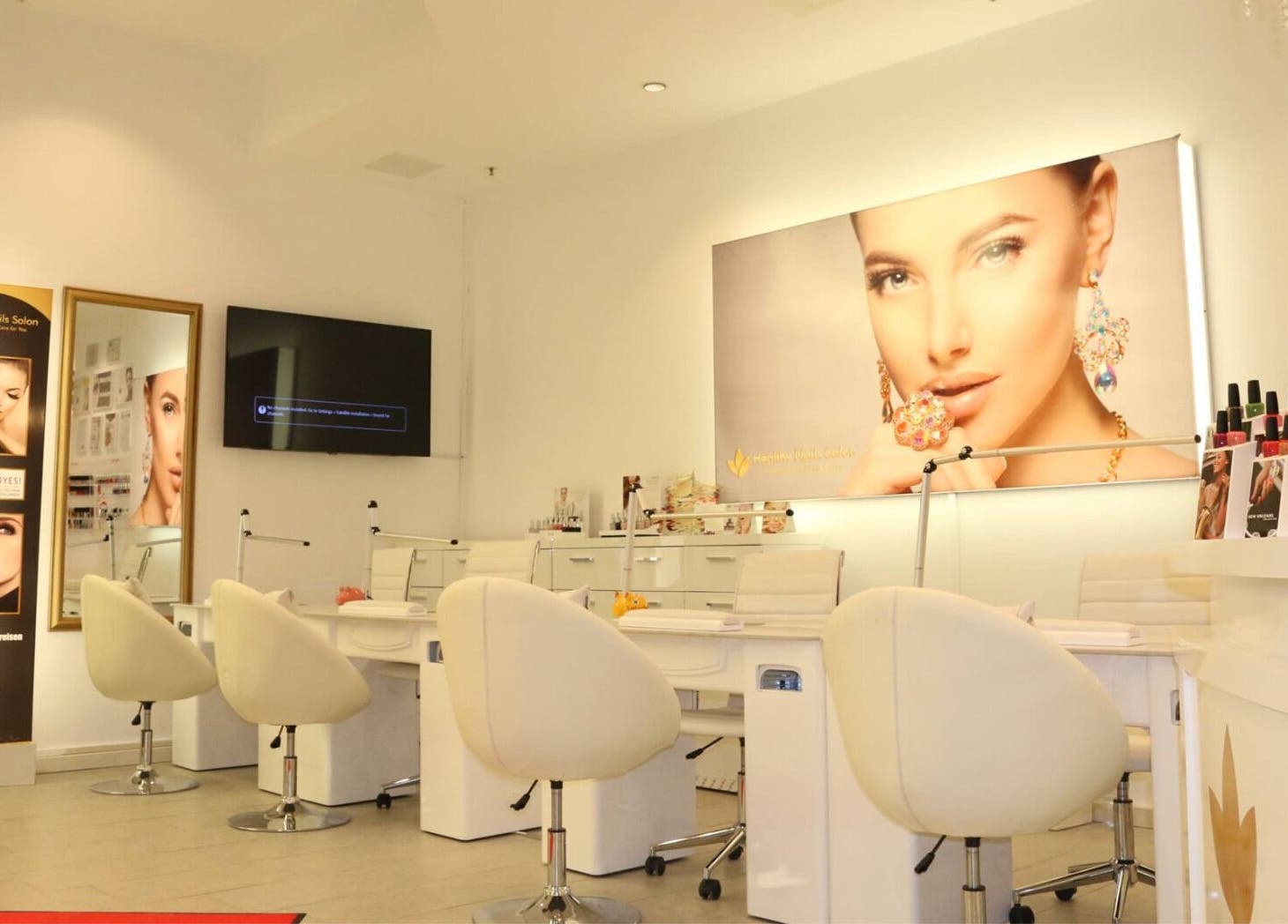 Innenansicht von Healthy Nails Salon in Kiel, Schleswig-Holstein, DE mit modernen weißen Sitzen und Wanddekoren.