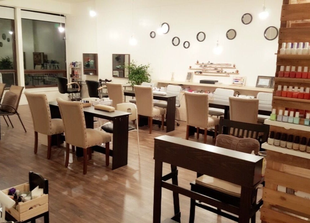 Chic nail salon interior at M&M Studio NYC, New York, US, featuring plush chairs and polished decor.