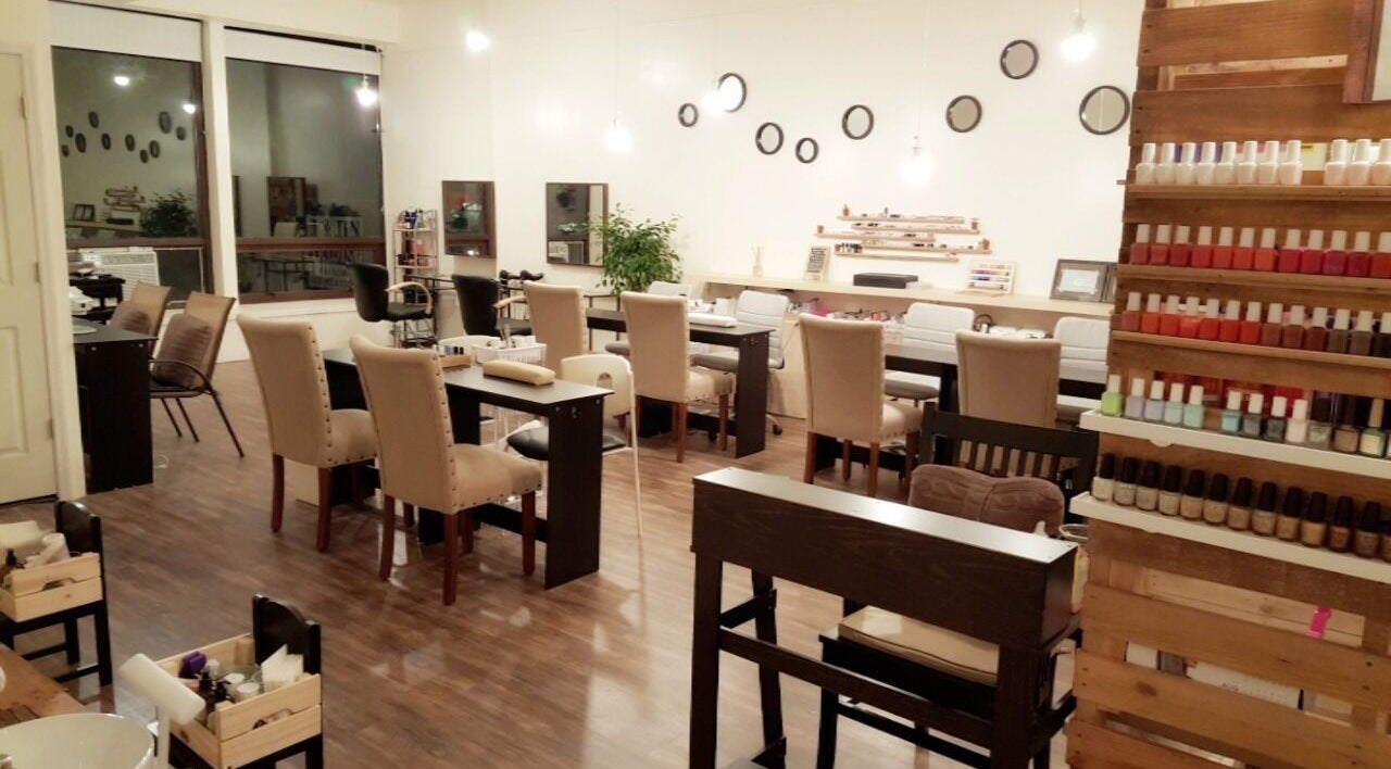 Chic nail salon interior at M&M Studio NYC, New York, US, featuring plush chairs and polished decor.