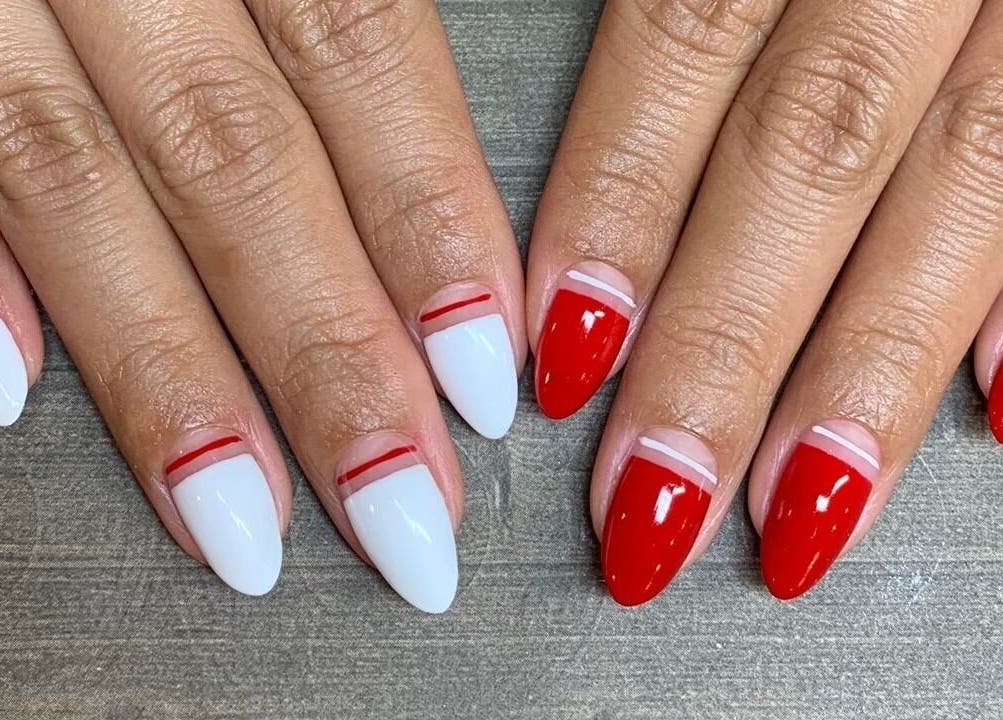 Red and white nail art by M&M Studio NYC in New York, New York, US. Perfect for stylish fashionistas.