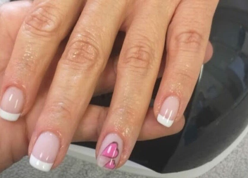 French manicure with heart detail at Thobs and Cleo Beauty Bar, Johannesburg, Gauteng, ZA.
