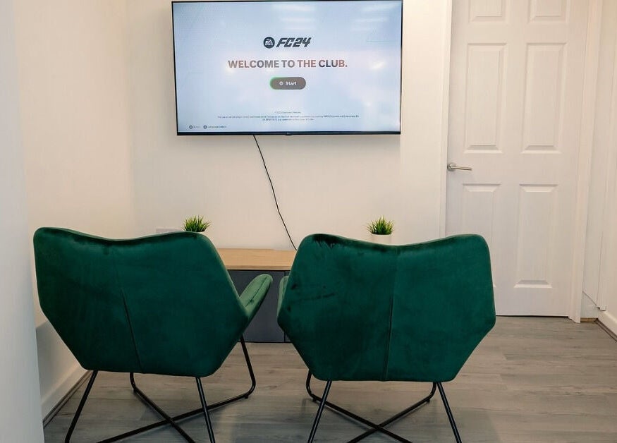 Relaxing lounge area with green chairs at Barbersanj in Willenhall, England, GB.