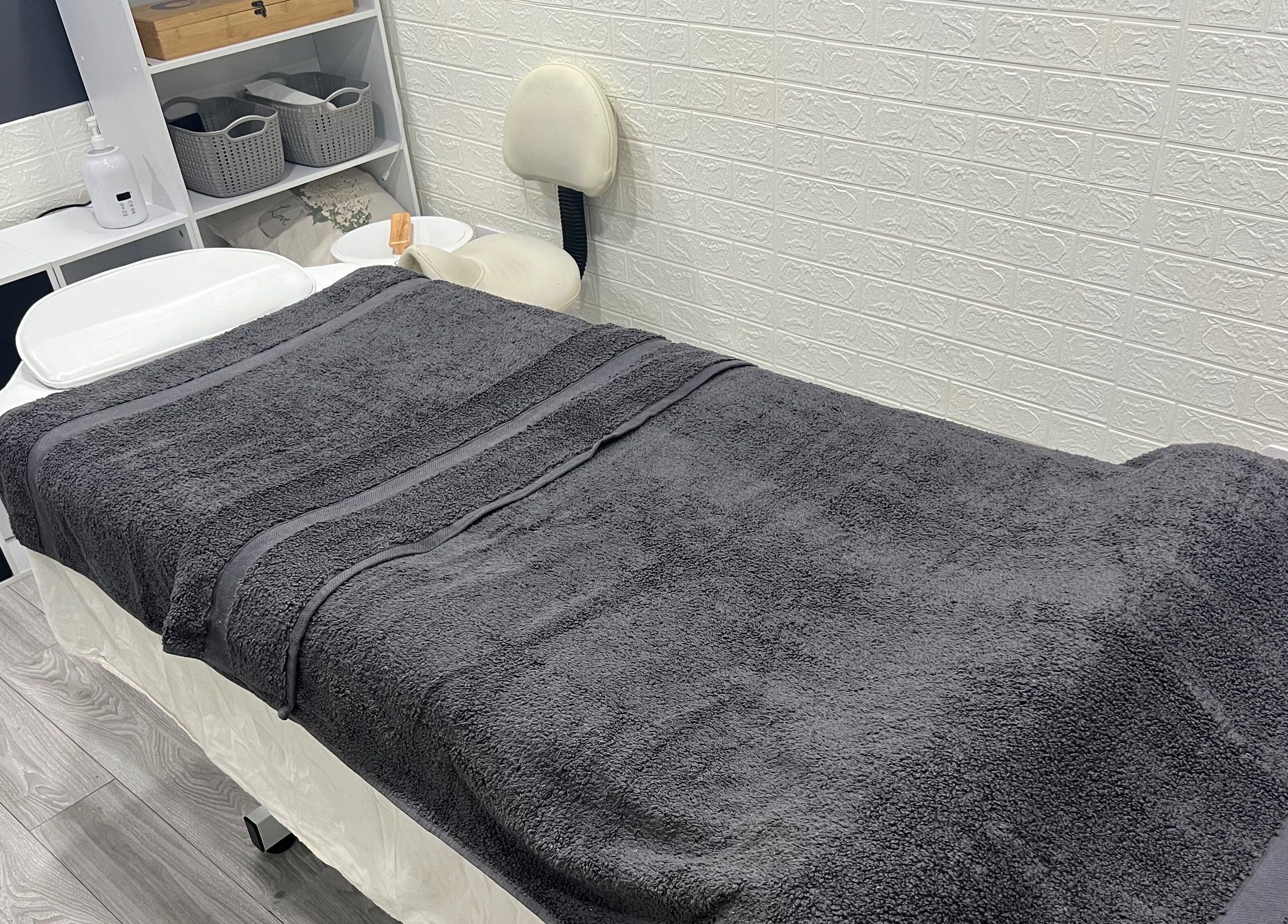 Peaceful massage room at AG Massages, Ash Vale, England, GB with cozy treatment table and calming decor.