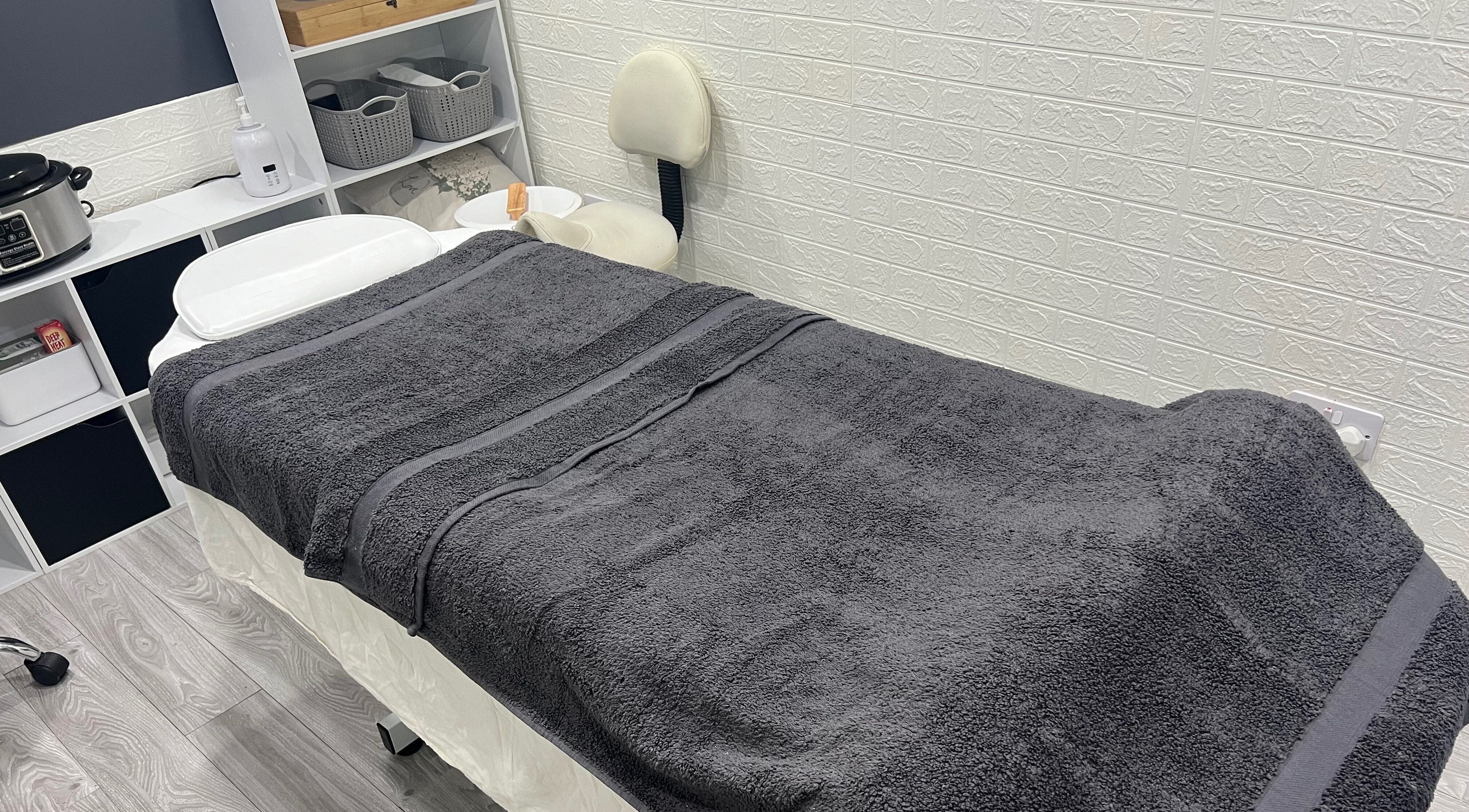 Peaceful massage room at AG Massages, Ash Vale, England, GB with cozy treatment table and calming decor.