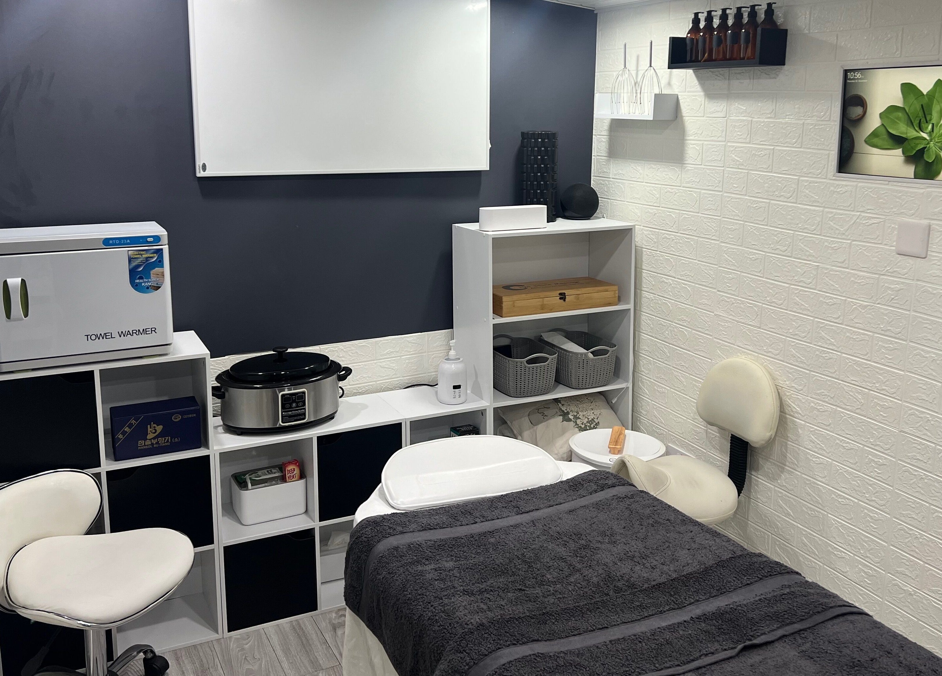 Calm massage room with towel warmer at AG Massages, Ash Vale, England, GB, offering a relaxing wellness experience.