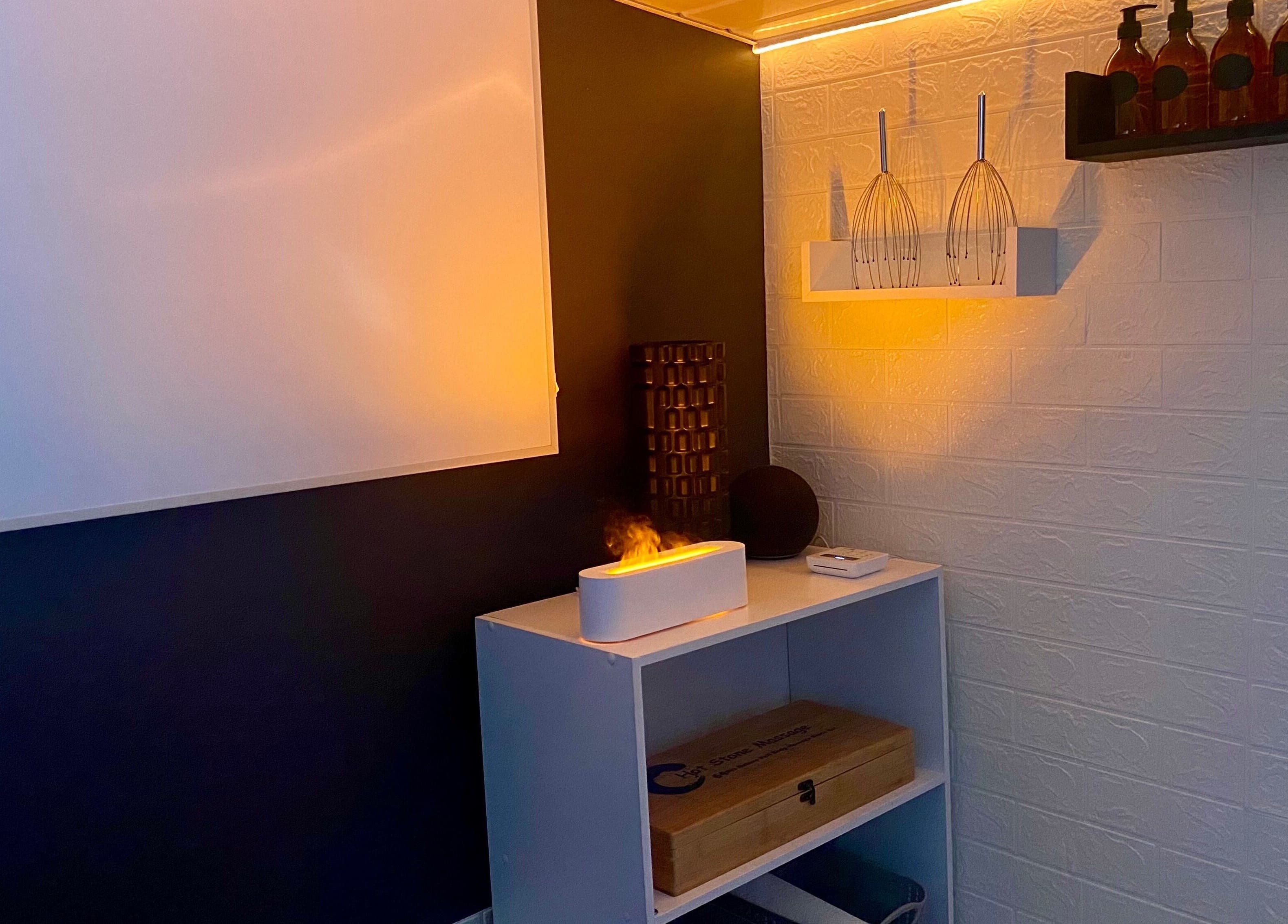 Tranquil corner with soft lighting at AG Massages, Ash Vale, England, GB featuring aromatherapy setup.