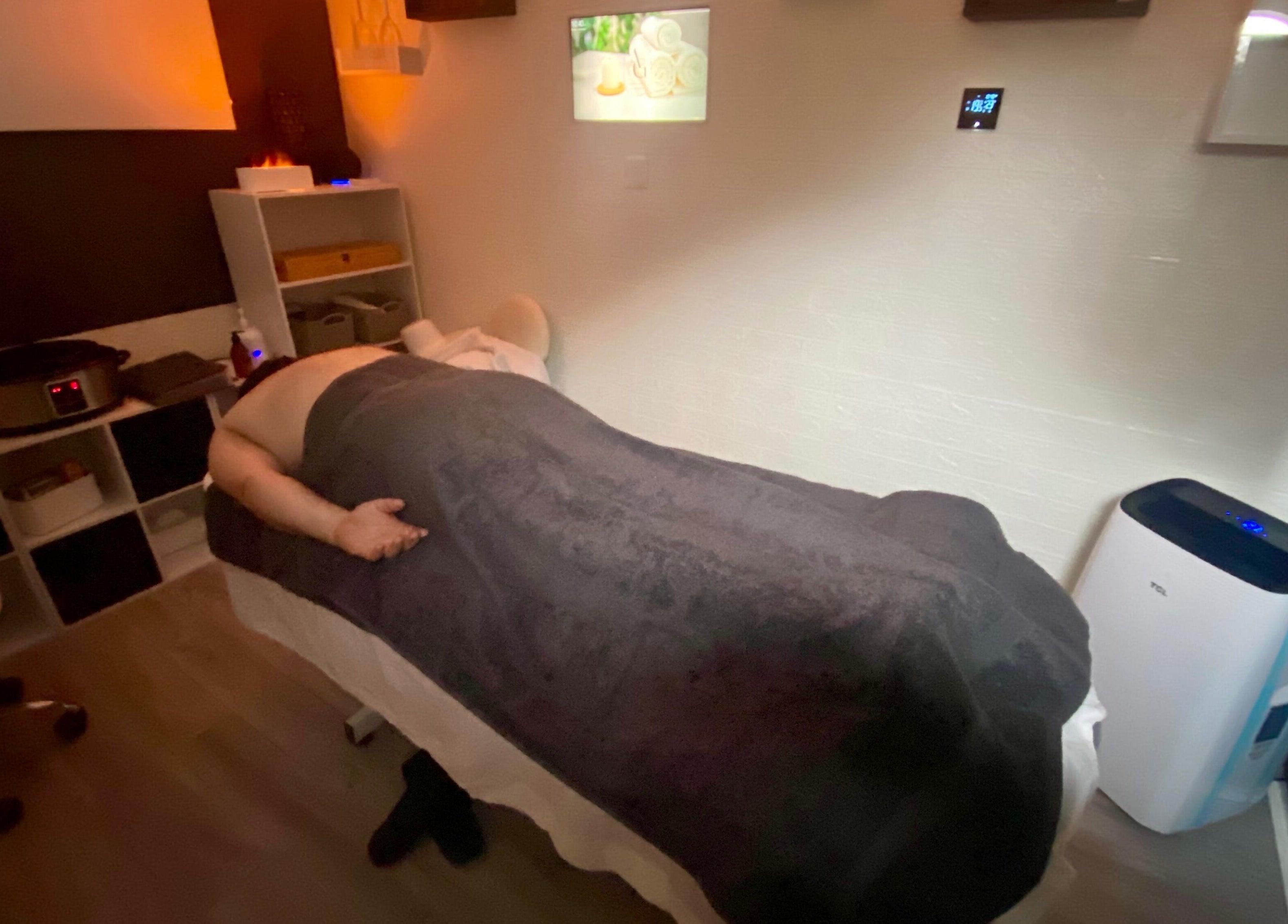 Relaxing massage room at AG Massages in Ash Vale, England, GB, featuring ambient lighting and a comfortable massage table.