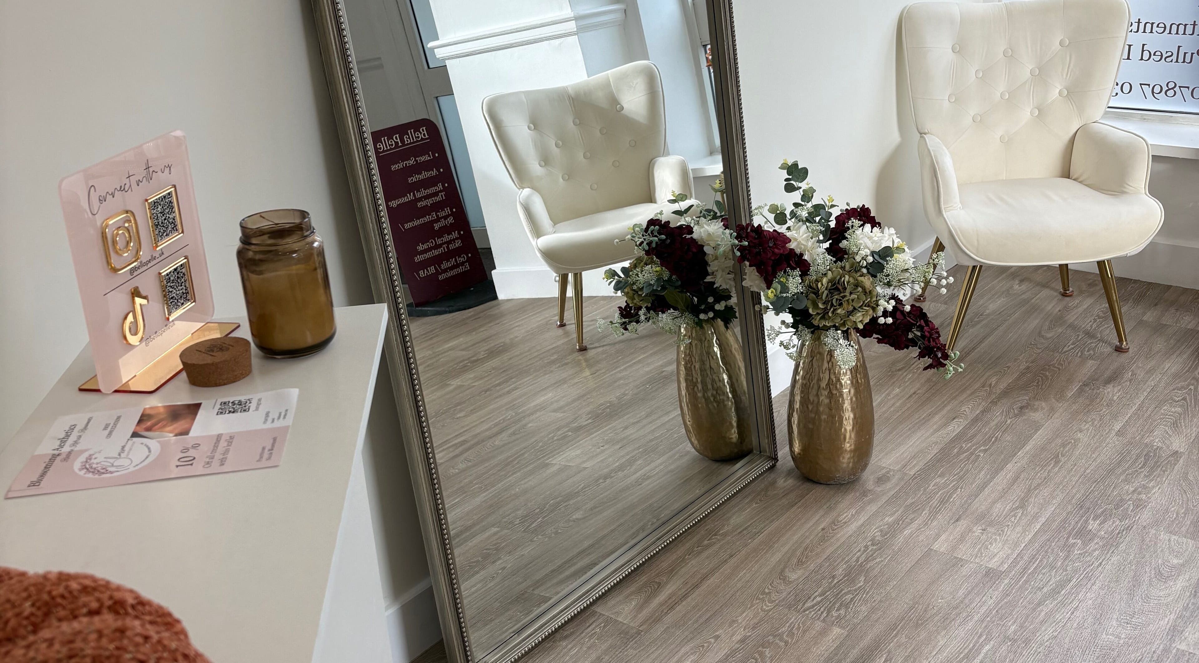 Luxurious seating and floral decor at By Leah, Whitley Bay, England, GB mirror reflection.