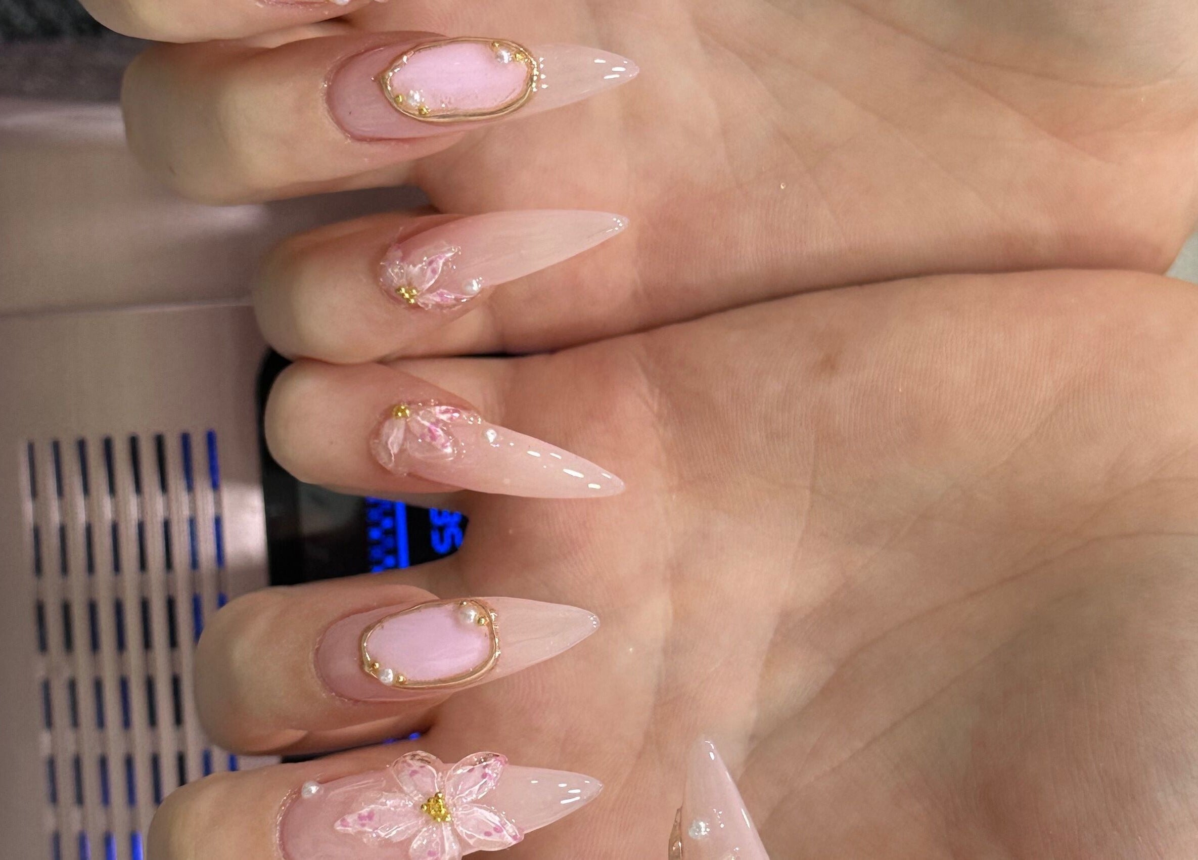 Intricate pink nail art with flowers at T & C Nails, London, England, GB.