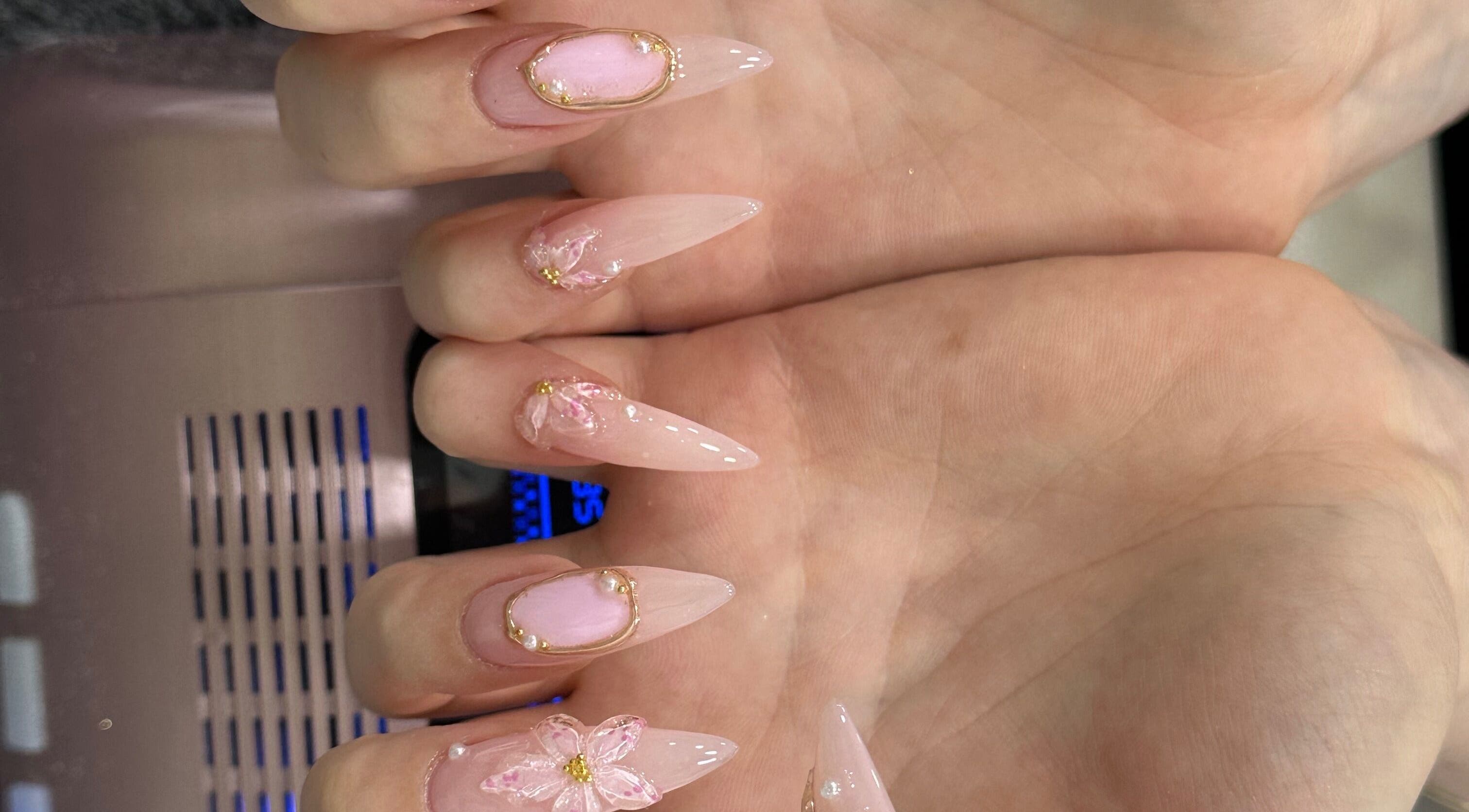 Intricate pink nail art with flowers at T & C Nails, London, England, GB.