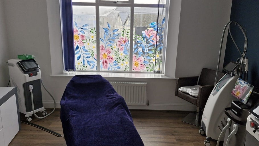 Chic treatment room at Wild Jasmine Retreat, Ramsbottom, England, GB with floral window art and modern equipment.