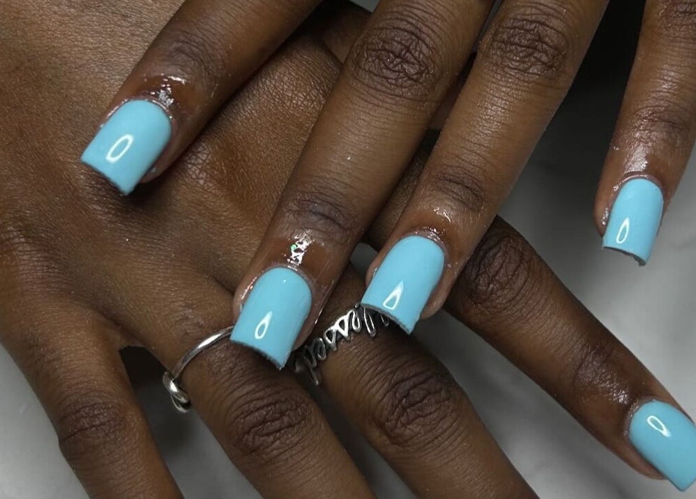 Stylish aqua nail art at Nails Byyp Imiya in Forney, Texas, US showcasing glossy manicure.
