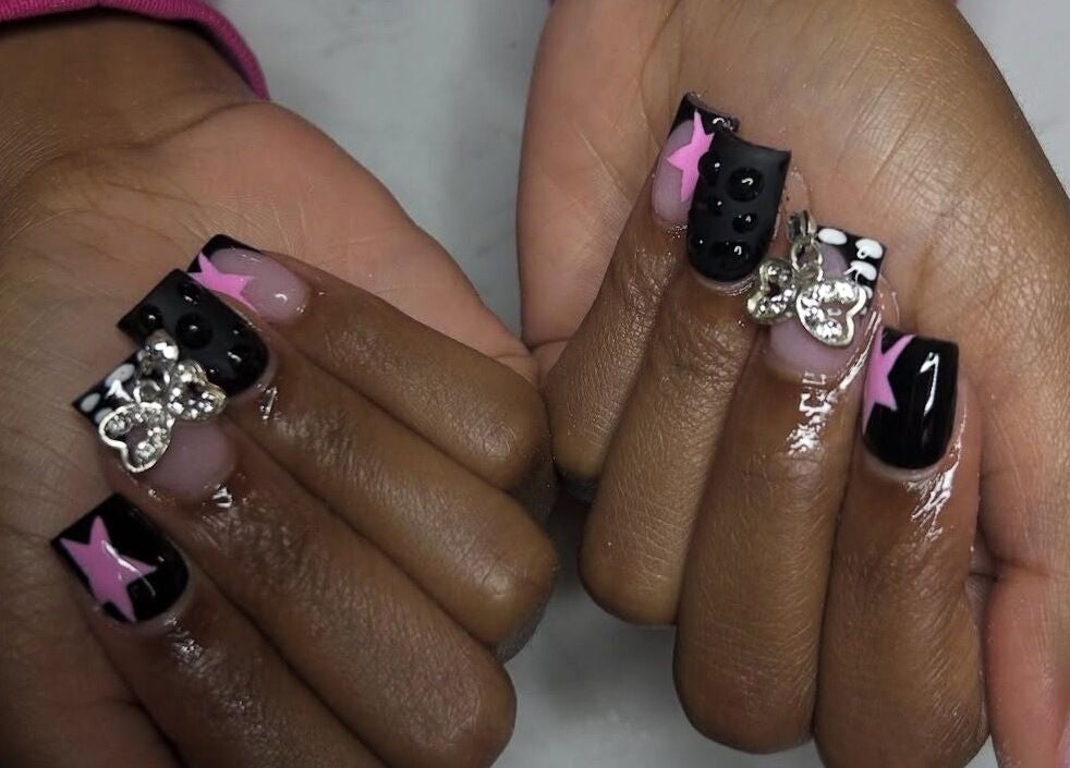 Glamorous nail art with pink stars and gems at Nails Byyp Imiya in Forney, Texas, US.