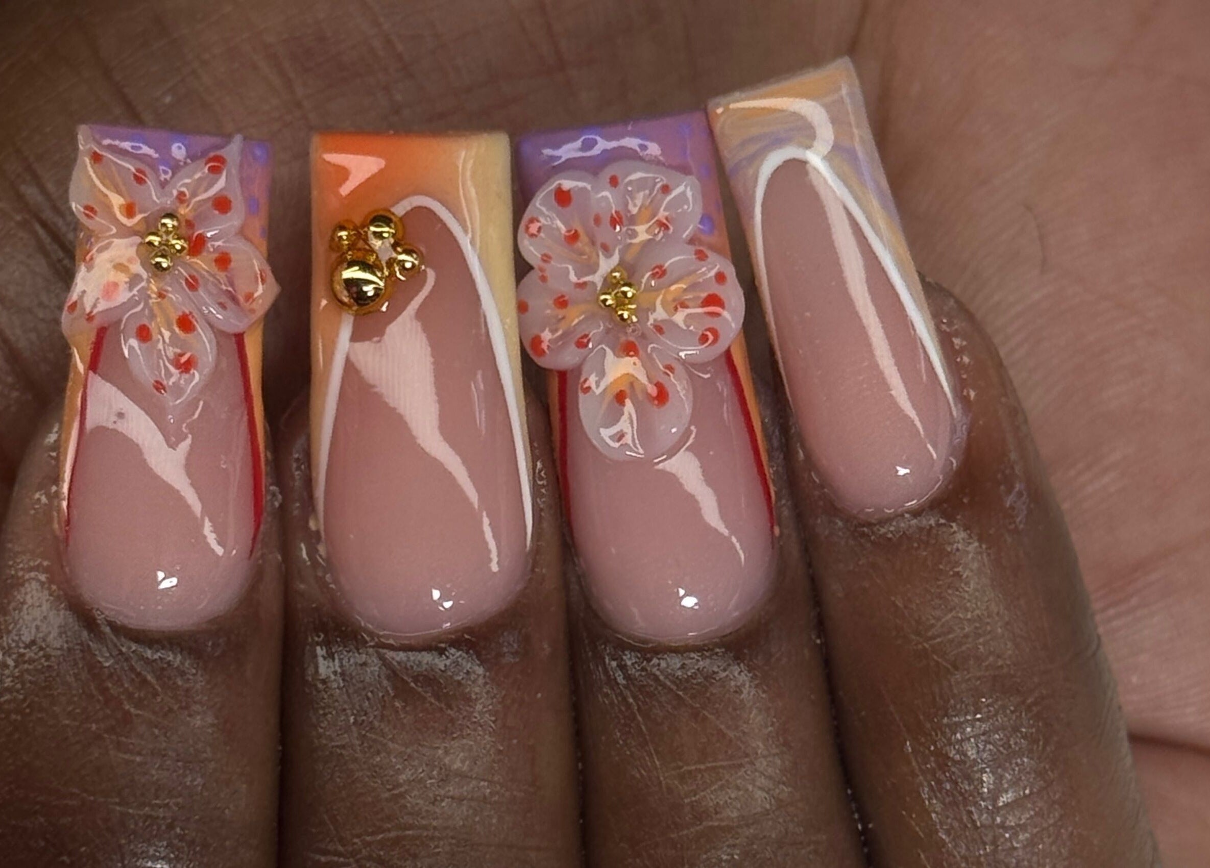 Elegant floral nail art at Luxura.Beauty in Willemstad, CW featuring intricate flower designs.