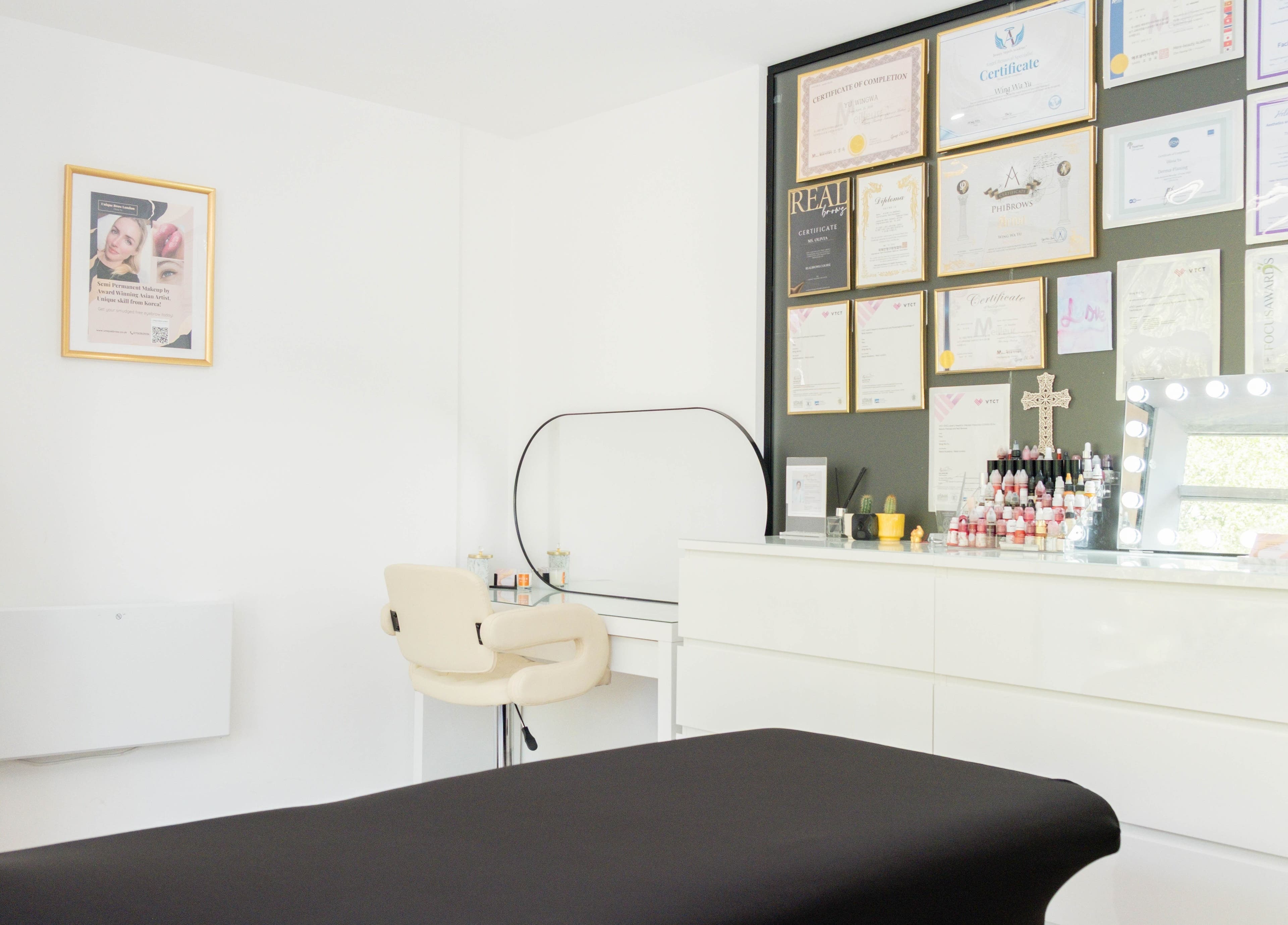 Chic interior of Unique Brow London, London, England, GB with certificates and makeup setup.