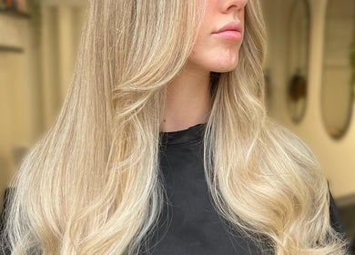 Blonde hair styled at Coloured by Madison in Plymouth, England, GB, showcasing smooth, flowing locks.