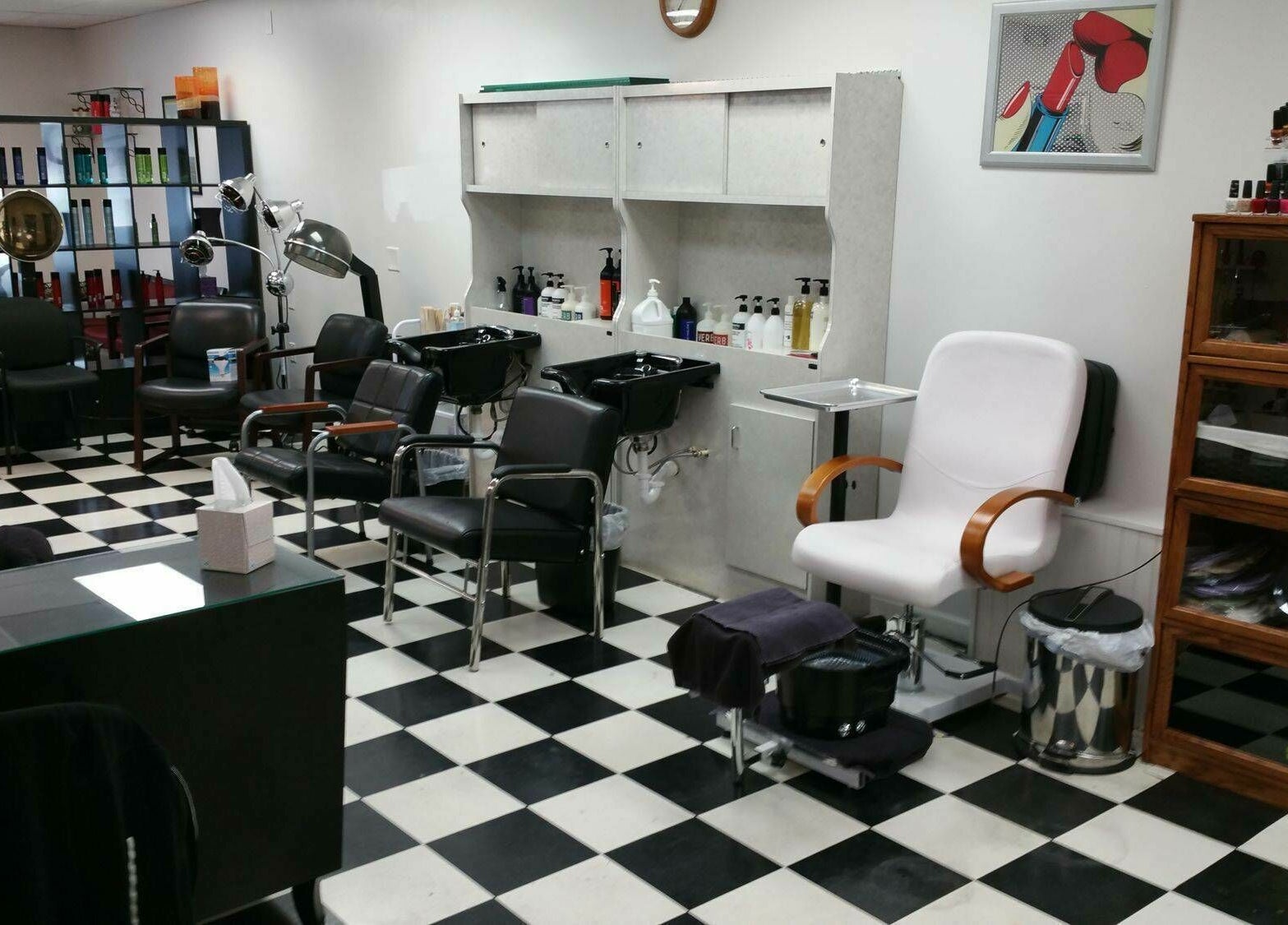 Stylish interior of All About Hair in Lewes, Delaware with salon chairs and hair products on display.