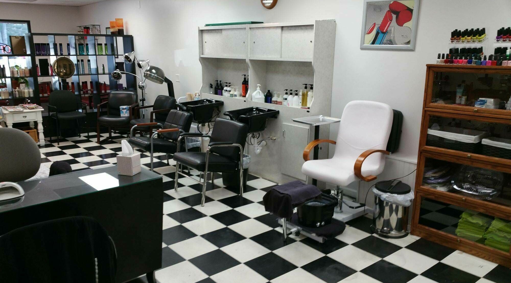 Stylish interior of All About Hair in Lewes, Delaware with salon chairs and hair products on display.