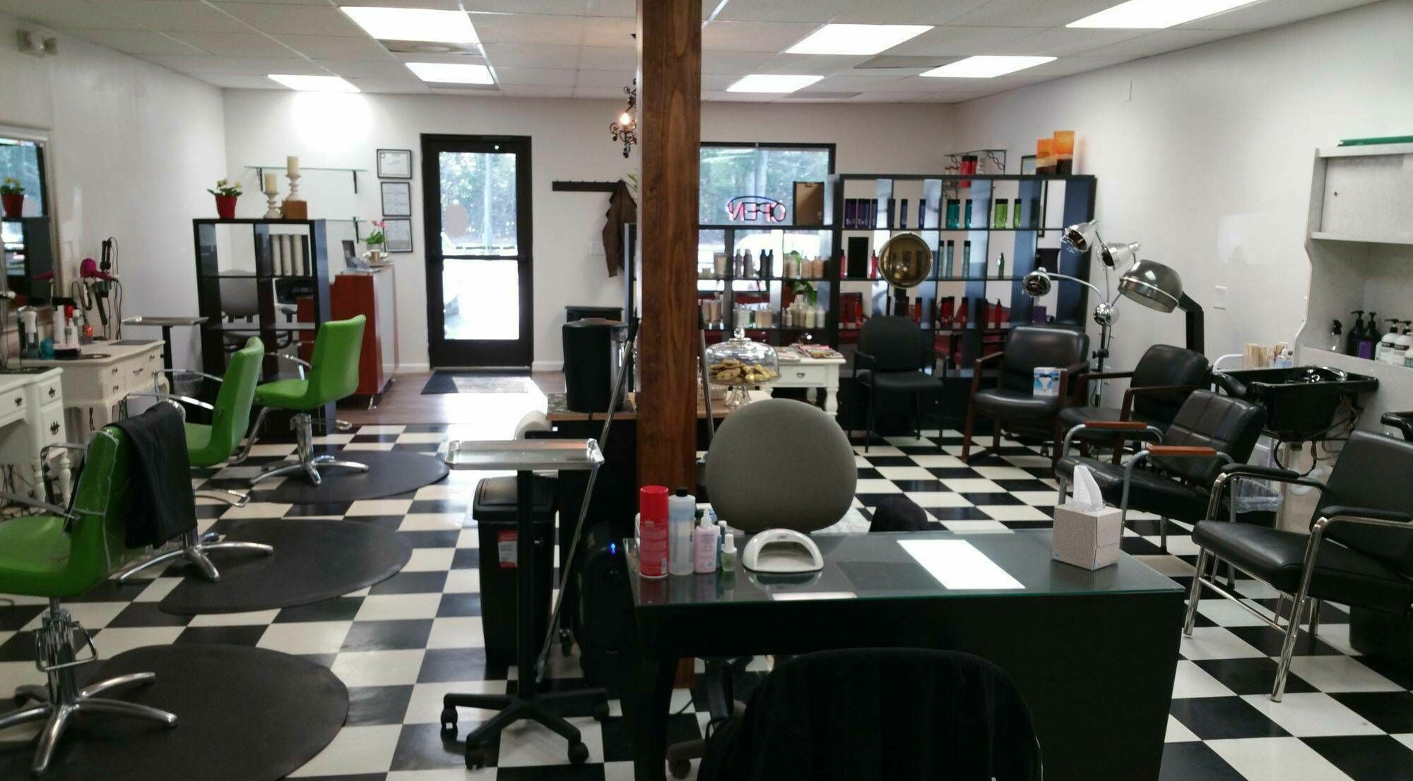 Chic interior of All About Hair salon in Lewes, Delaware, US featuring vibrant chairs and modern decor.