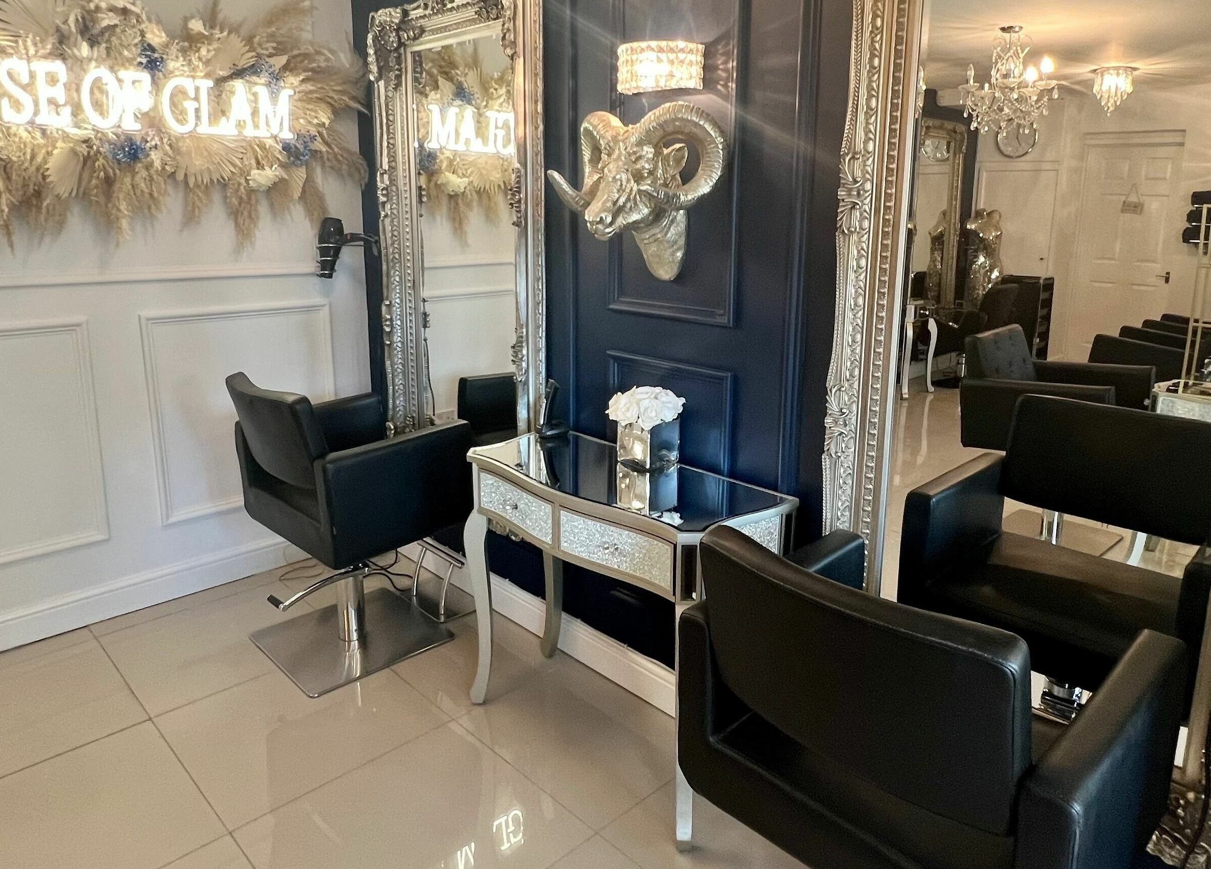 Elegant salon interior at Ludicrous Lengths, Thornbury, England, GB with plush black chairs and ornate mirrors.