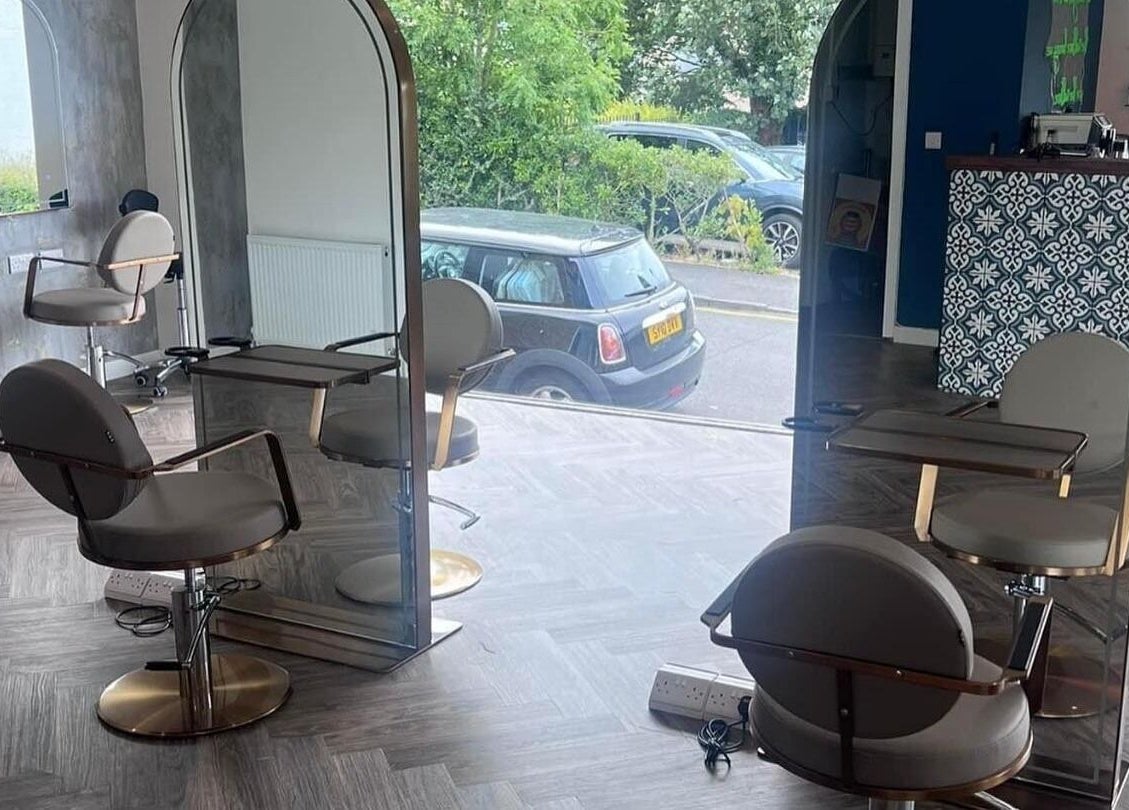 Modern salon interior at Hair by Olivia Bain in Kirkintilloch, Scotland, GB, showcasing stylish chairs and mirrors.
