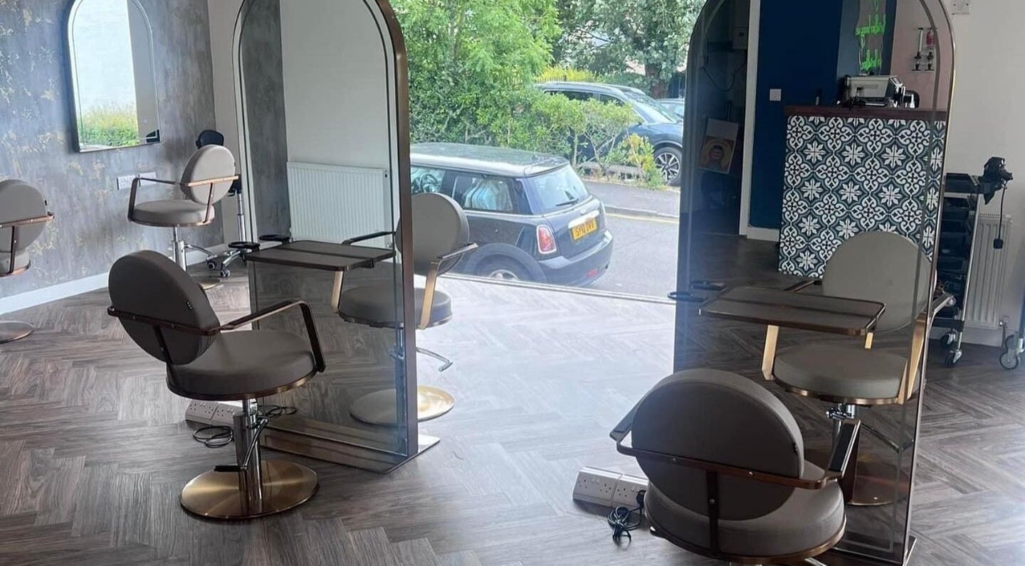Modern salon interior at Hair by Olivia Bain in Kirkintilloch, Scotland, GB, showcasing stylish chairs and mirrors.