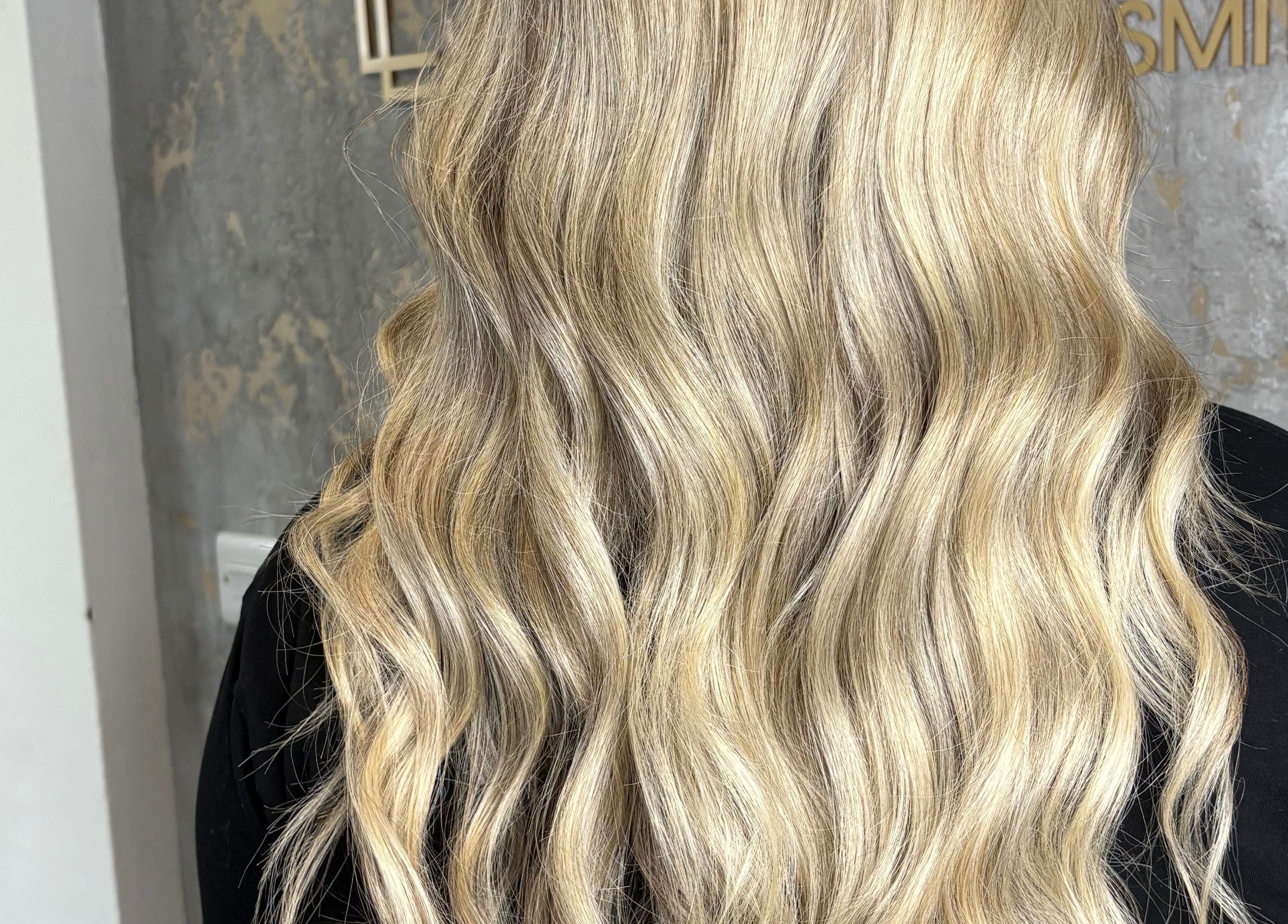 Blonde wavy hair styled at Hair by Olivia Bain, Kirkintilloch, Scotland, GB, showcasing salon expertise.