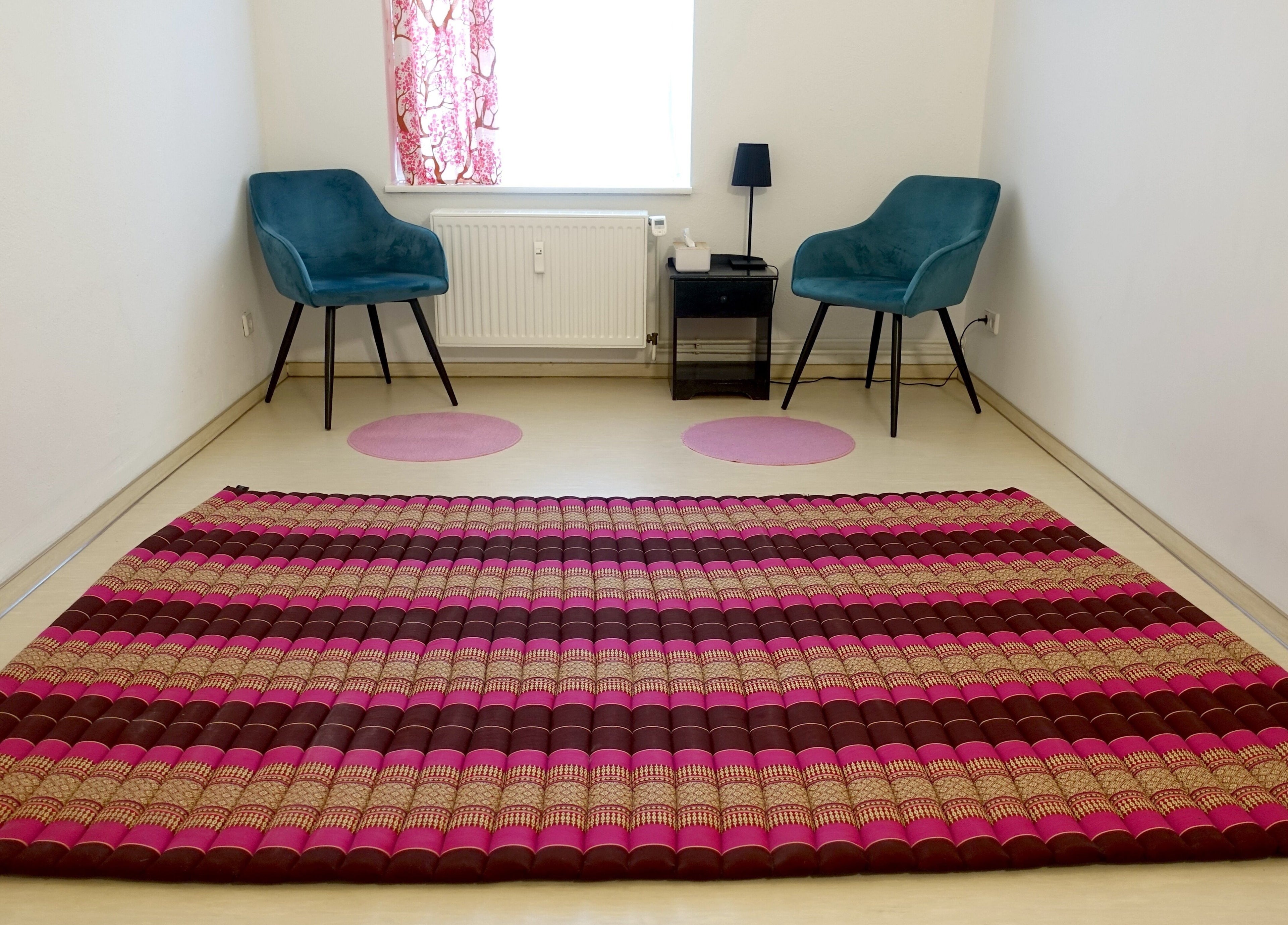 Cozy therapy room with mat and chairs at Hirai Healing East at HAVEN, Berlin, Berlin, DE.
