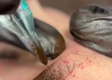 Close-up of microblading procedure at G’lamore Ink & Beauty, Birmingham, England, GB, showcasing expert technique.
