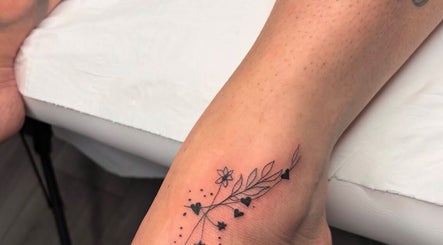 Floral tattoo design on a foot at G’lamore Ink & Beauty, Birmingham, England, GB.