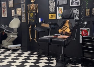 G’lamore Ink & Beauty tattoo room in Birmingham, England, GB featuring a stylish chair and artistic decor.