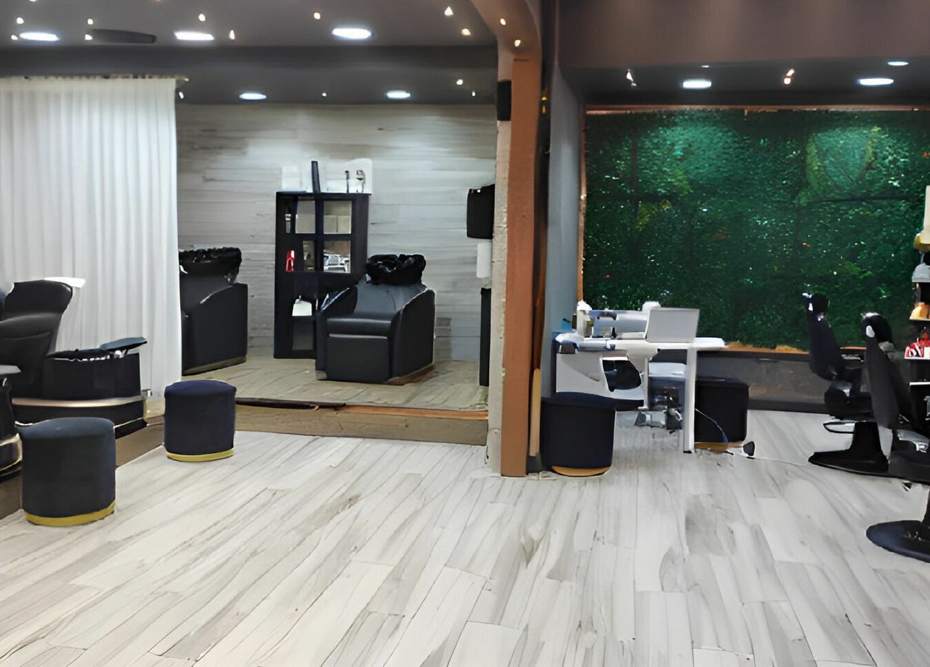 Chic interior of Fit Social salon in Dubai, Dubai, AE with modern chairs and lush greenery wall.