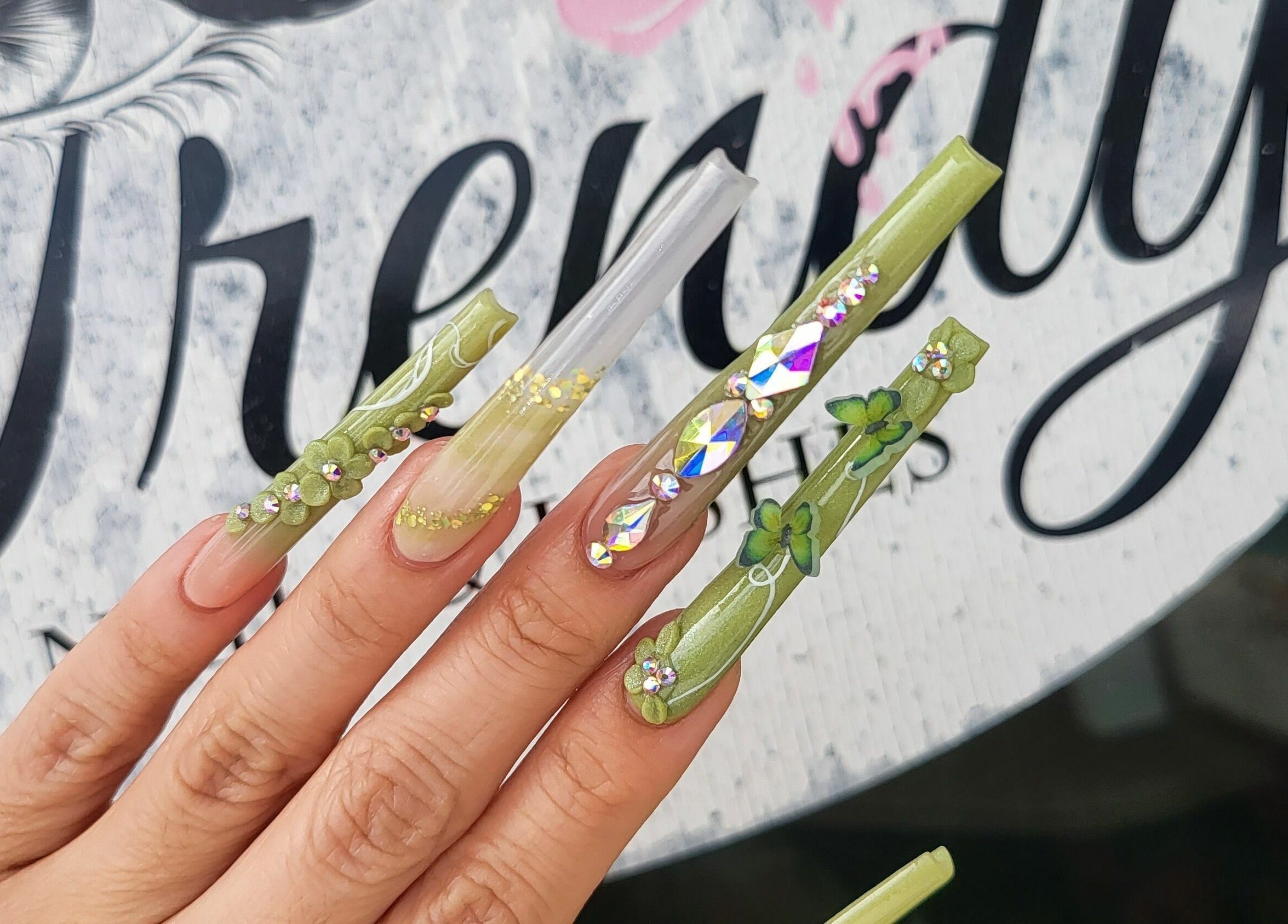 Stylish green embellished nails at Trendy Nails Spa, Scottsdale, Arizona, US.