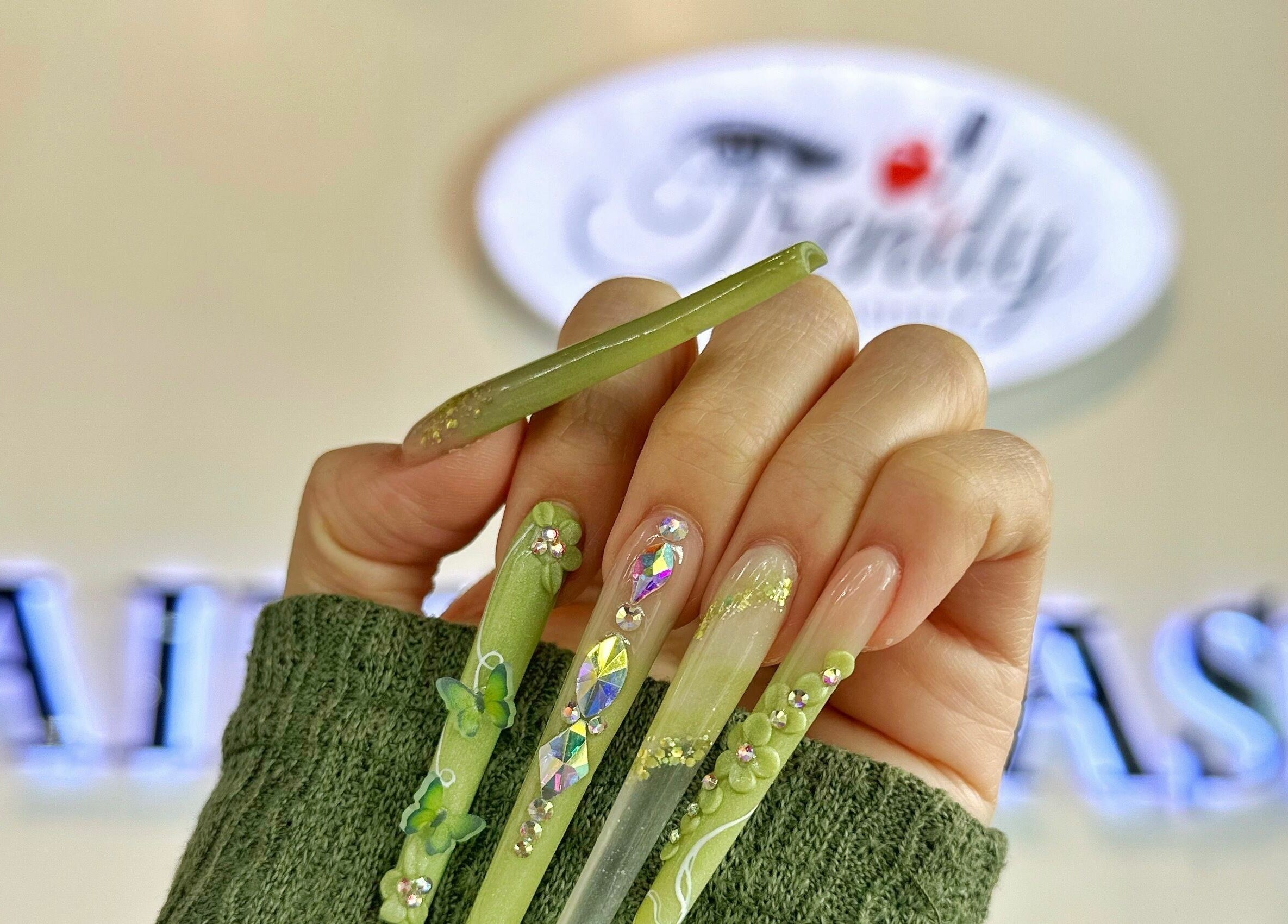Close-up of intricately designed green nails at Trendy Nails Spa, Scottsdale, Arizona, US.
