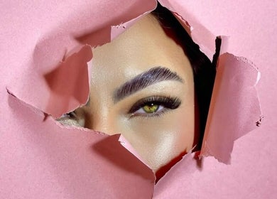 Elegant eye with lash extension seen through ripped pink paper at Olivio George • Lash Designer • Extensão de Pestanas •, Lisboa.