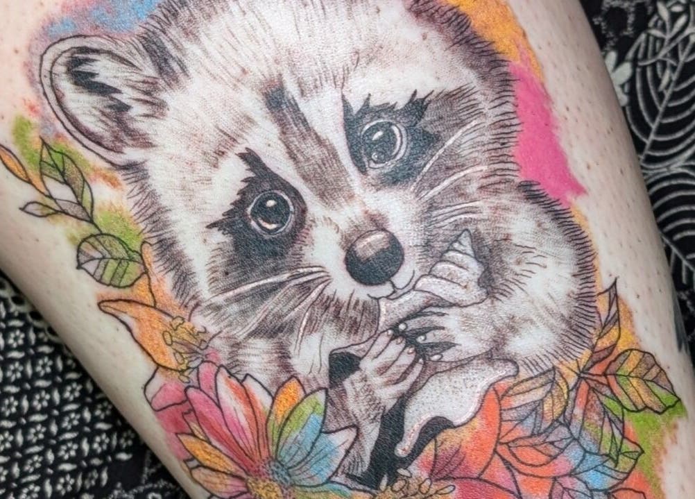 Detailed raccoon tattoo with colorful flowers at Sarah Welsh - Tattoo & Permanent Makeup, Dunfermline, Scotland, GB.