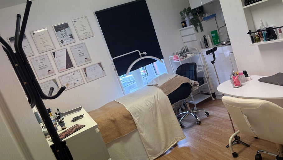 Treatment room at Baileys Beauty Boutique, Newport Pagnell, England, GB, featuring a massage bed and certificates.