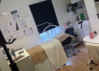 Treatment room at Baileys Beauty Boutique, Newport Pagnell, England, GB, featuring a massage bed and certificates.