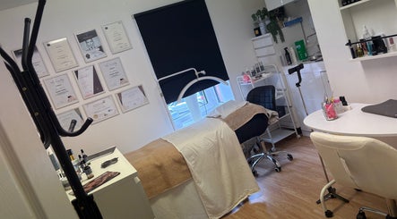 Treatment room at Baileys Beauty Boutique, Newport Pagnell, England, GB, featuring a massage bed and certificates.