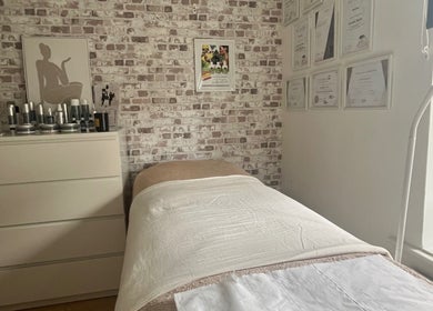 Cozy treatment room at Baileys Beauty Boutique, Newport Pagnell, England, GB. Features bed, decor, and certificates.