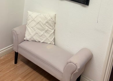 Elegant seating area at Baileys Beauty Boutique, Newport Pagnell, England, GB, featuring a plush cushion.