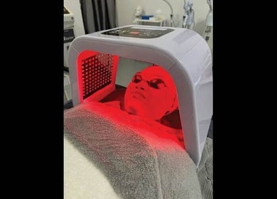 LED light facial therapy at Dr Lauranne Bangi in DENGKIL, SELANGOR, MY. Client relaxes under red light therapy.