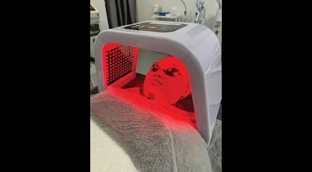 LED light facial therapy at Dr Lauranne Bangi in DENGKIL, SELANGOR, MY. Client relaxes under red light therapy.