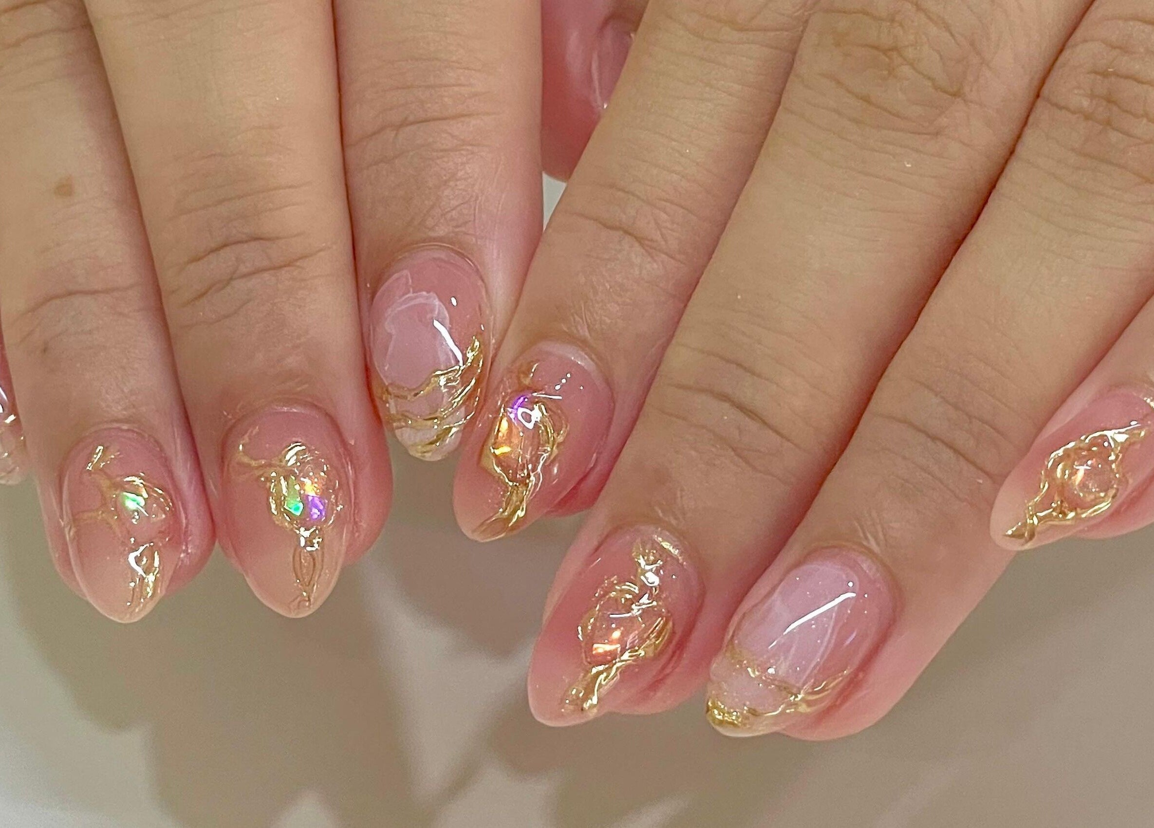 Elegant nail art with gold accents at Allurix Nail Salon, Singapore, Singapore, SG. Trendy manicure design.