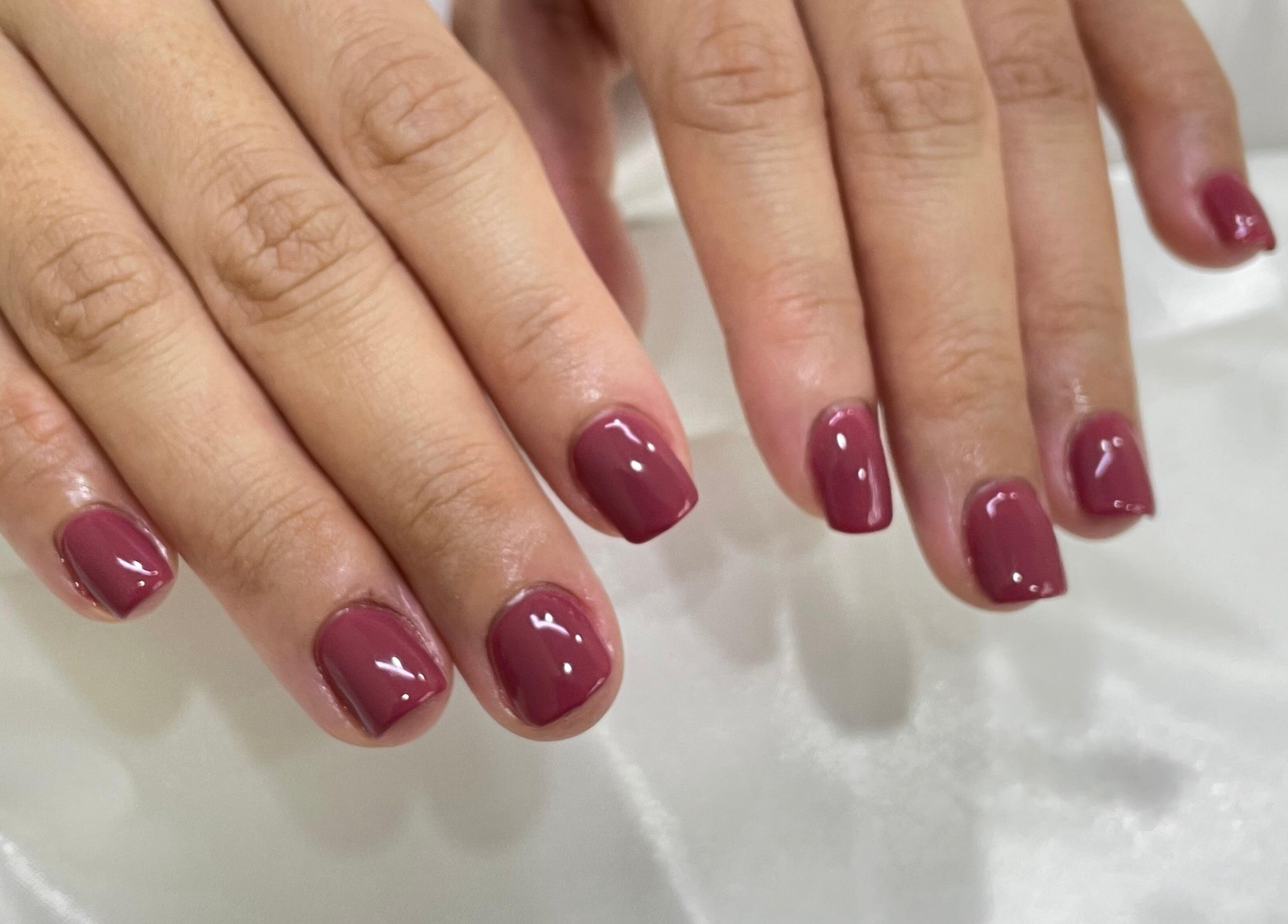 Glossy burgundy nails at Allurix Nail Salon, Singapore, Singapore, SG, showcasing expert manicure services.