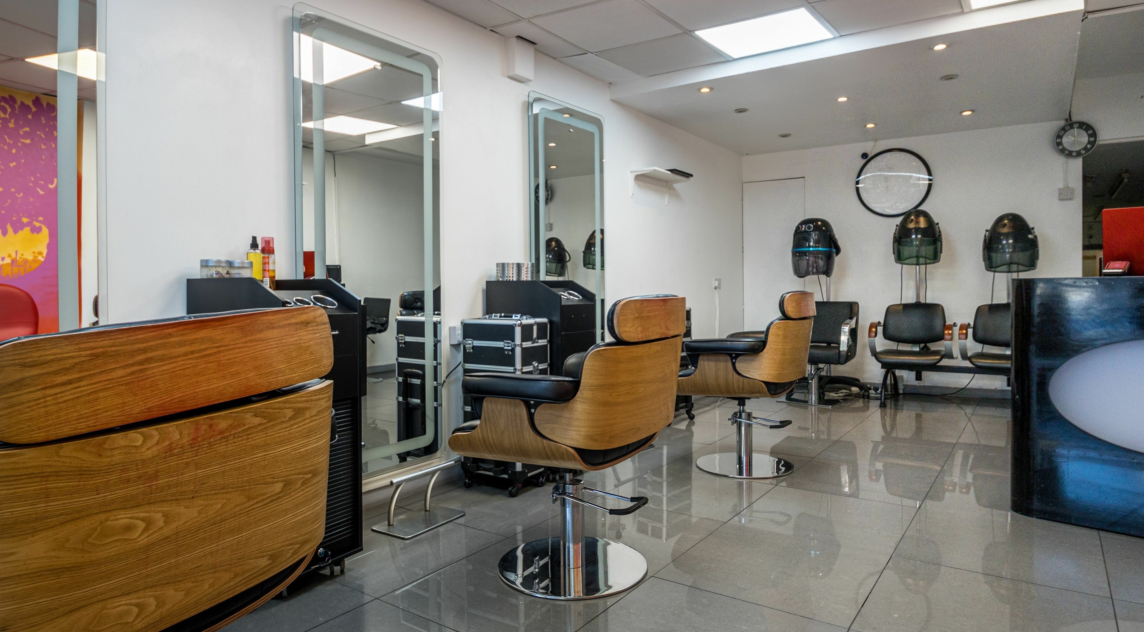 Interior of London Locs salon in London, England, GB featuring modern chairs and hair stations.