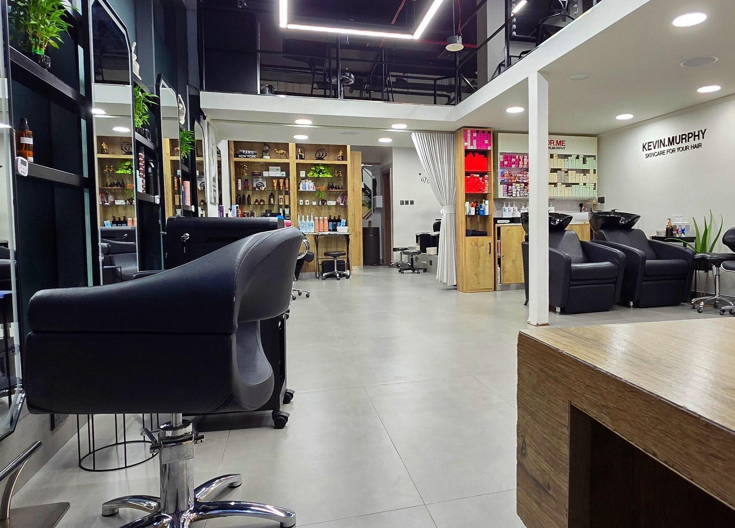 Interior view of TREVI SALON, Dubai, Dubai, AE, showcasing modern styling chairs and shelves with beauty products.