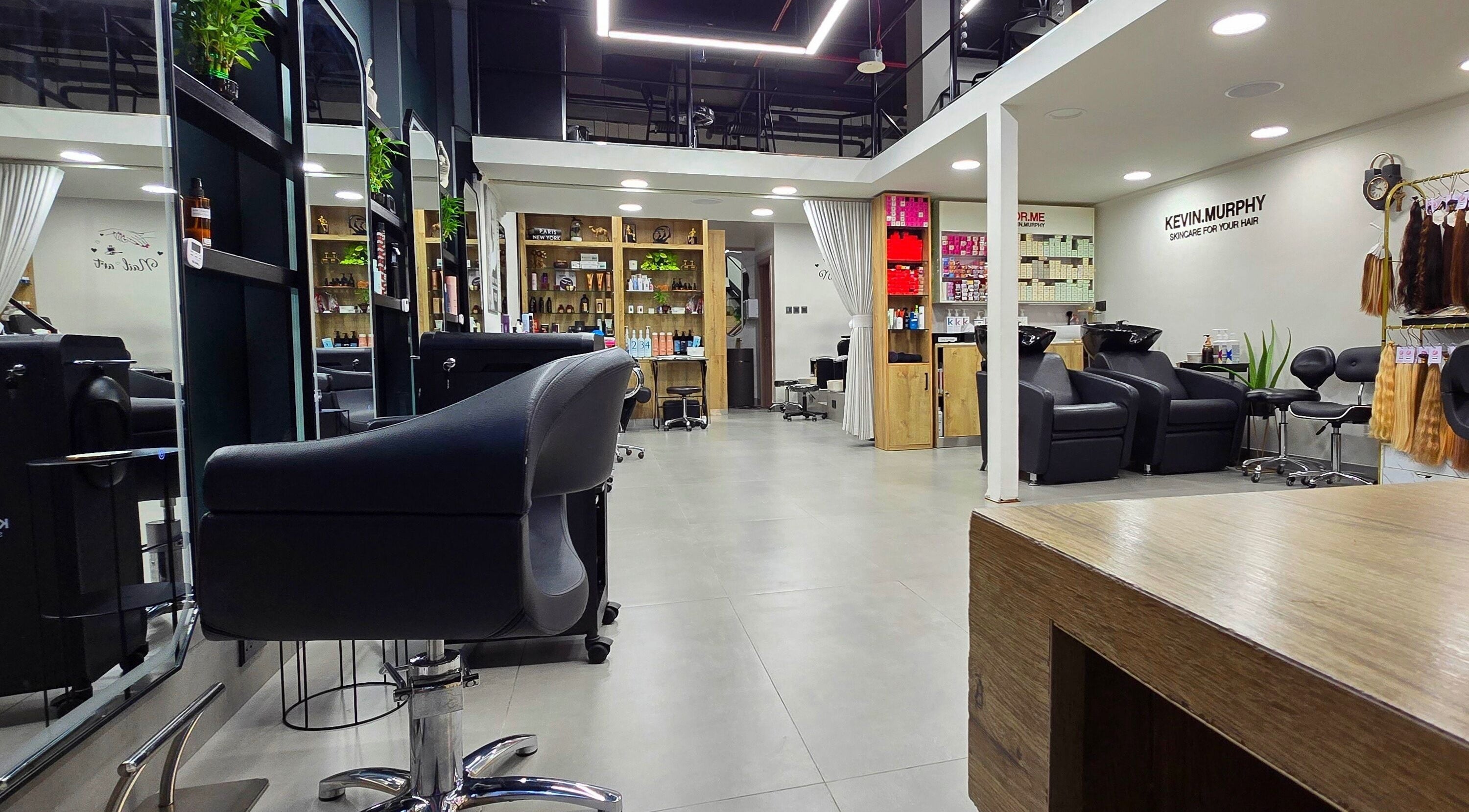 Interior view of TREVI SALON, Dubai, Dubai, AE, showcasing modern styling chairs and shelves with beauty products.